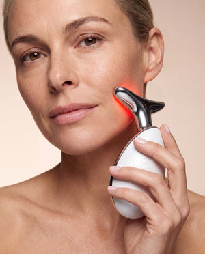 Woman using the Beaulyco Sculpt Pro LED Face & Neck Massager during her skincare routine.