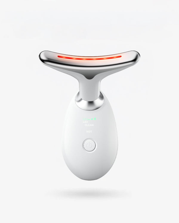White and silver facial massager with red light on a white background